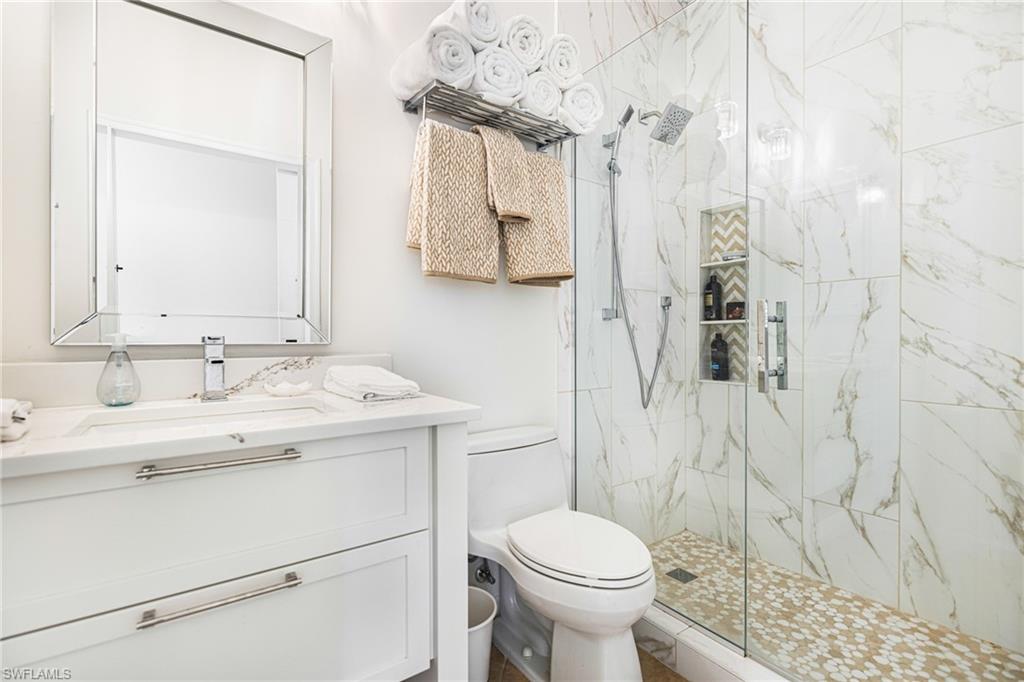 19071 Ridgepoint Drive, Unit 202 Estero, FL 33928 - Photo 10 of 26 a bathroom with a sink a toilet and shower