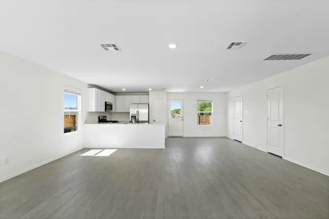 a view of a kitchen with furniture and wooden floor