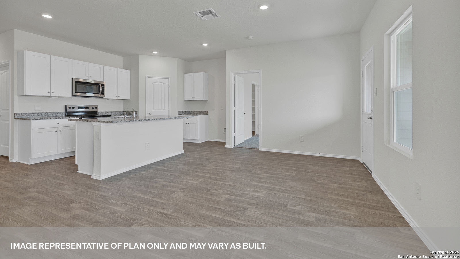 335 Boatman Cove Seguin, TX 78155 - Photo 18 of 38 a large white kitchen with kitchen island a sink a stove a microwave and cabinets