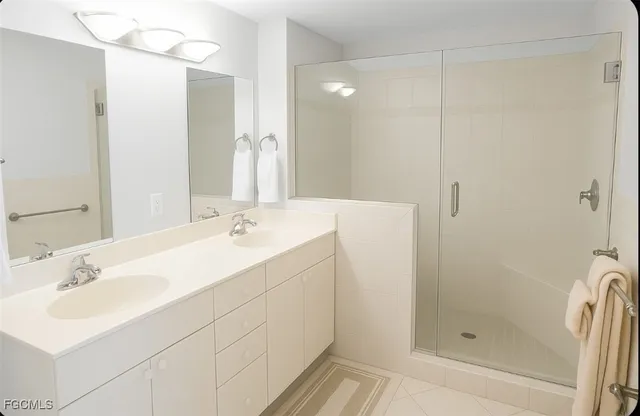 a bathroom with a shower sink and mirror