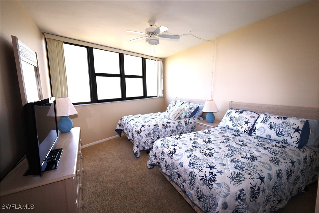 58 North Collier Boulevard, Unit 1103 Marco Island, FL 34145 - Photo 12 of 19 a bedroom with two beds and a flat screen tv