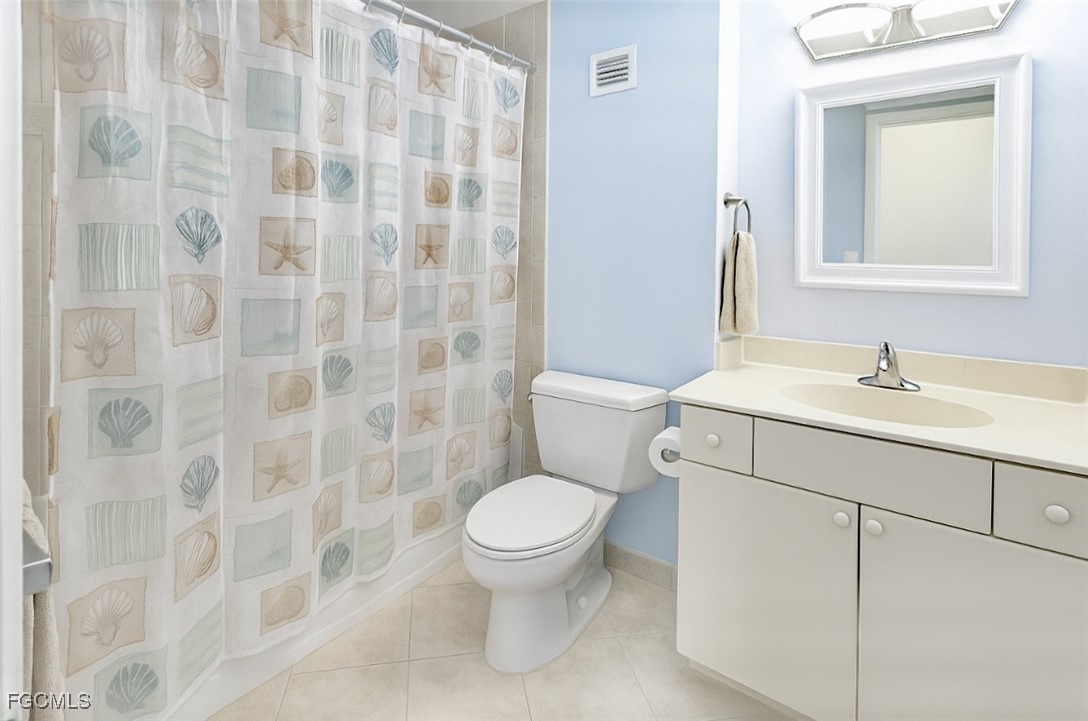58 North Collier Boulevard, Unit 1103 Marco Island, FL 34145 - Photo 13 of 19 a bathroom with a sink a toilet and a mirror