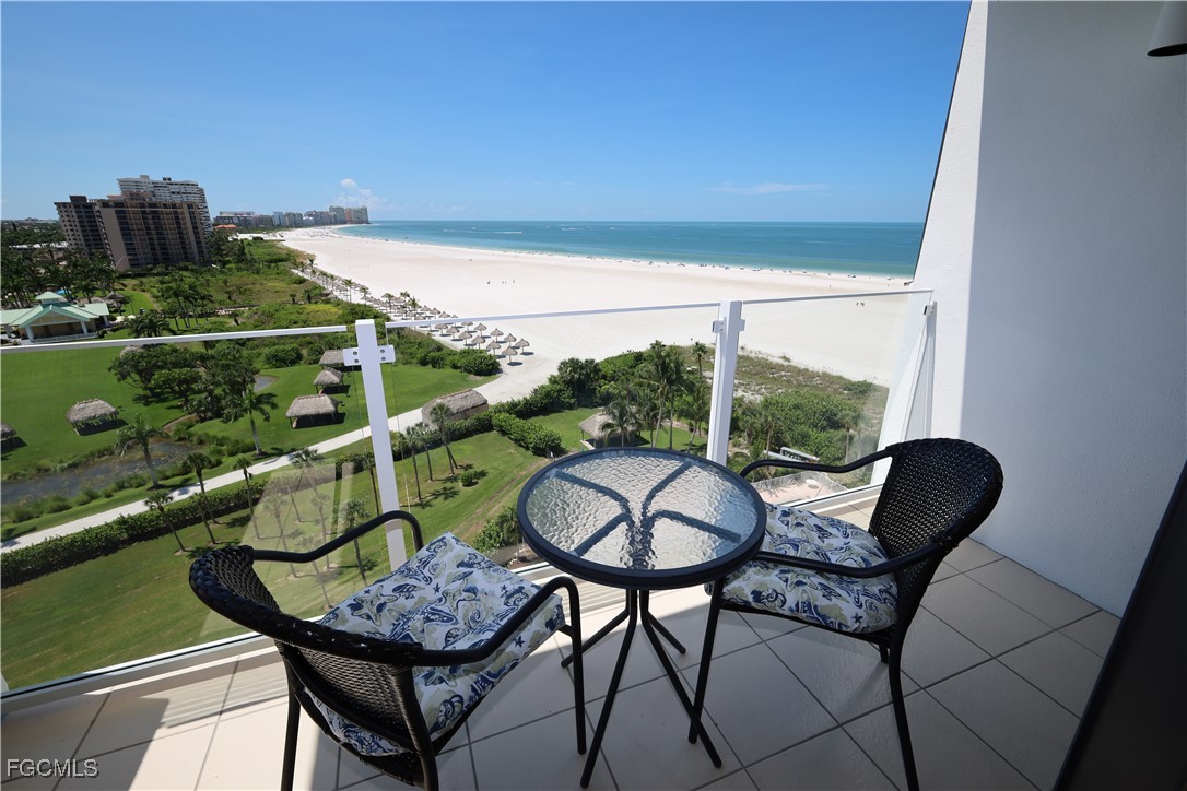 58 North Collier Boulevard, Unit 1103 Marco Island, FL 34145 - Photo 15 of 19 a view of a chairs and table in patio