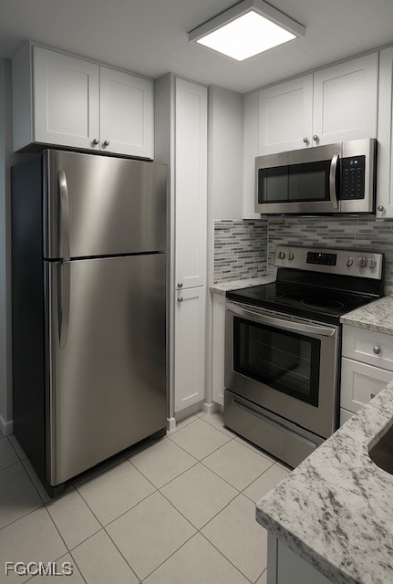 58 North Collier Boulevard, Unit 1103 Marco Island, FL 34145 - Photo 2 of 19 a kitchen with granite countertop a refrigerator and a stove top oven