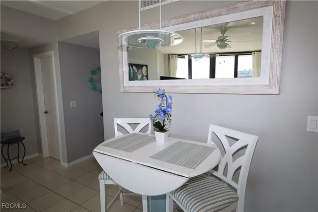 a view of a dining room with furniture and a potted plant