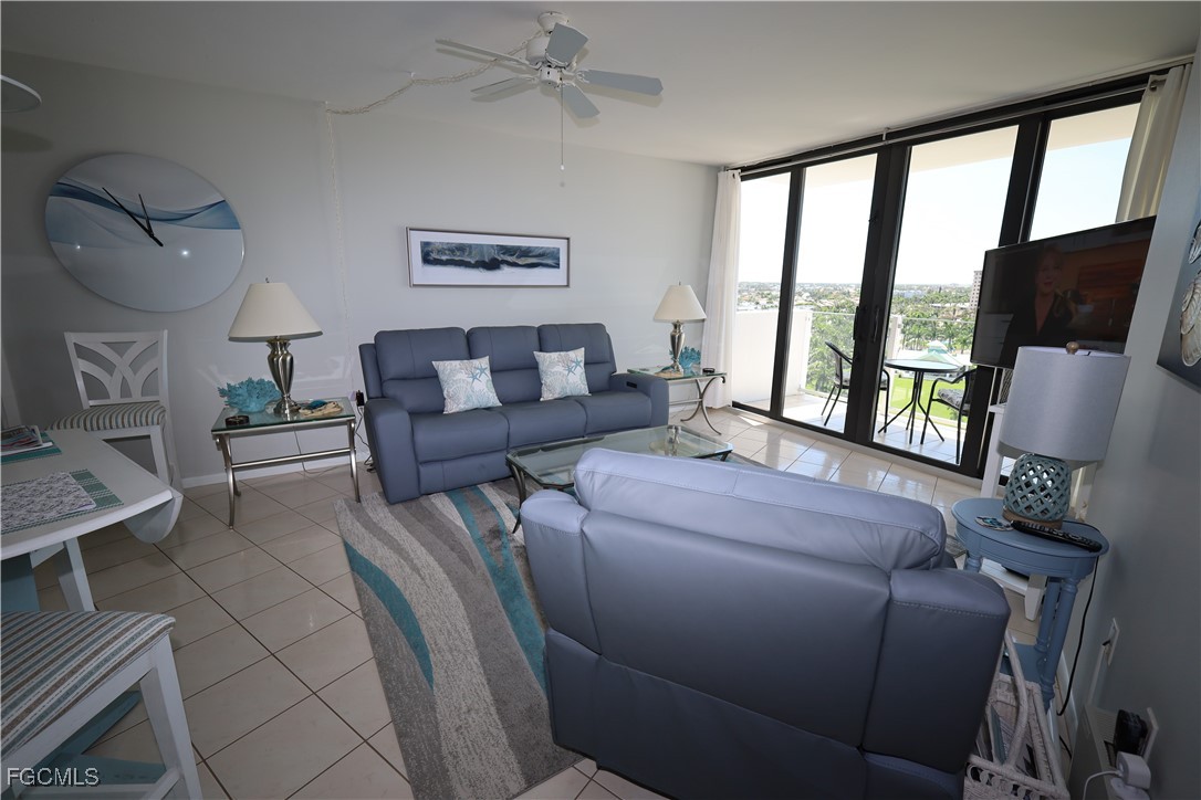 58 North Collier Boulevard, Unit 1103 Marco Island, FL 34145 - Photo 5 of 19 a living room with furniture and a flat screen tv