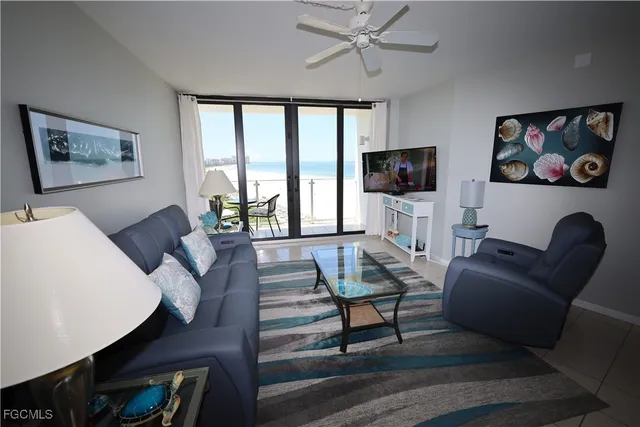 a living room with furniture a rug and a flat screen tv