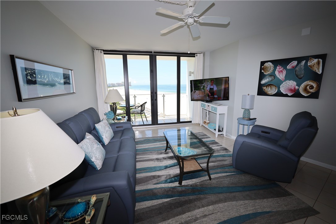 58 North Collier Boulevard, Unit 1103 Marco Island, FL 34145 - Photo 6 of 19 a living room with furniture a rug and a flat screen tv