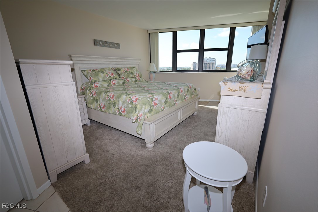 58 North Collier Boulevard, Unit 1103 Marco Island, FL 34145 - Photo 7 of 19 a bedroom with a bed and a window