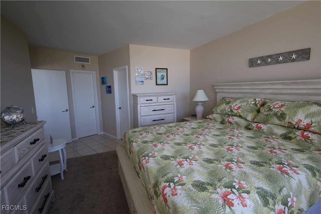 58 North Collier Boulevard, Unit 1103 Marco Island, FL 34145 - Photo 8 of 19 a bed room with a bed and a dresser