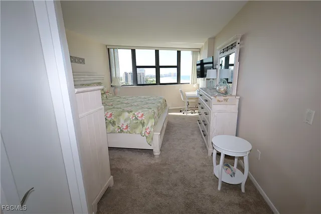 a view of a room with window and furniture