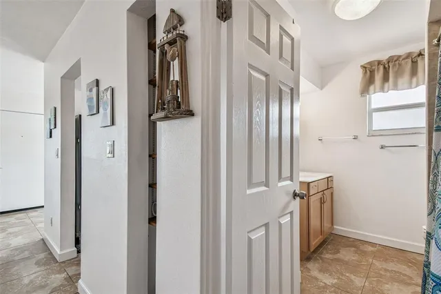 a bathroom with a sink vanity and shower