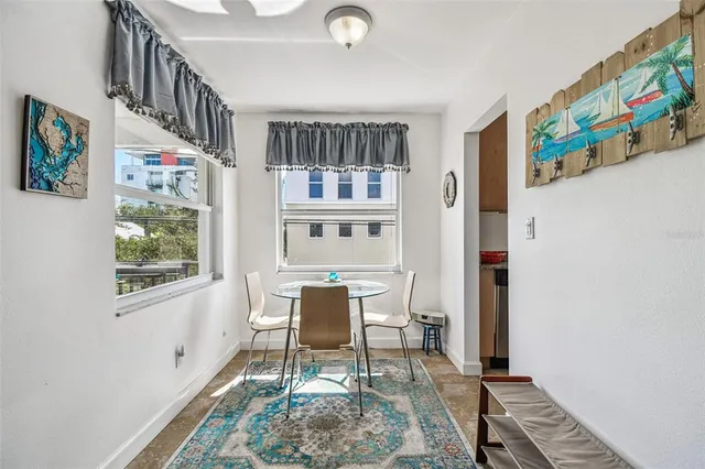 a dining room with furniture and a window