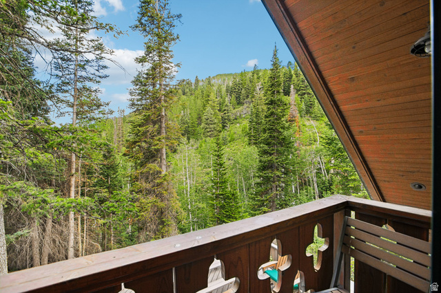 10205 East Moose Loop Road Salt Lake City, UT 84121 - Photo 35 of 50 Balcony featuring wood railing with decorative cut-outs and a wood-paneled ceiling