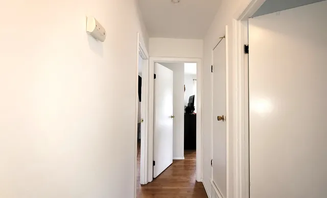 a view of a bathroom with a shower and a mirror