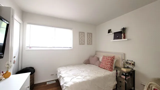 a bedroom with a bed and a flat screen tv