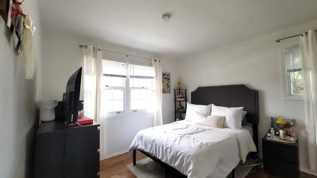 a bedroom with a bed and a window