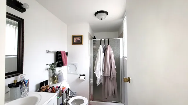 a bathroom with a sink toilet and shower