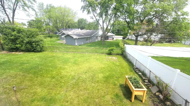a view of a backyard with swimming pool