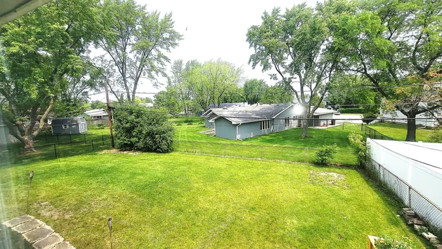 a view of a backyard with large trees