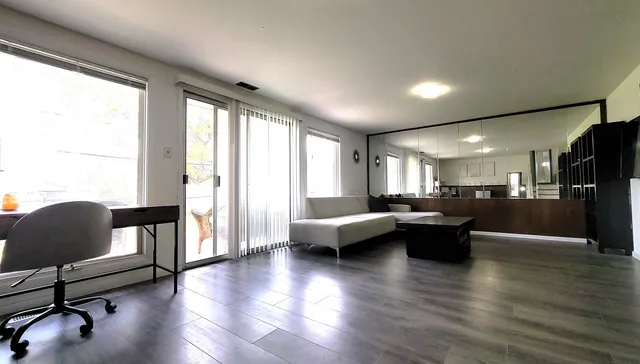 a living room with furniture window and wooden floor