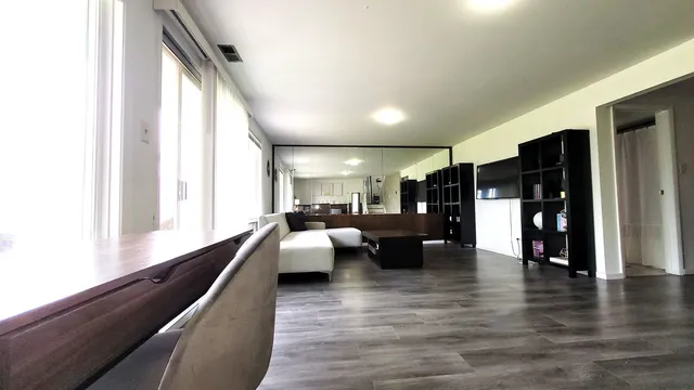 a living room with couches and a large window