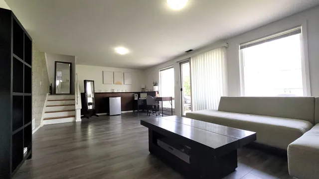 a living room with furniture and wooden floor