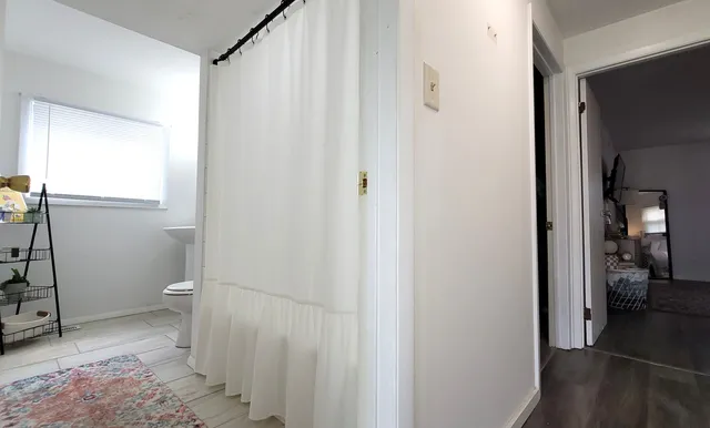 a bathroom with a granite countertop toilet and a shower