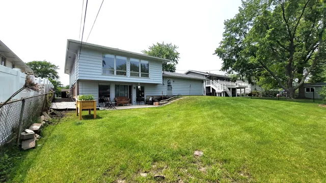 a view of house with a yard
