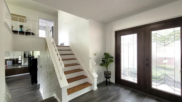 a view of wooden floor and entryway in a room