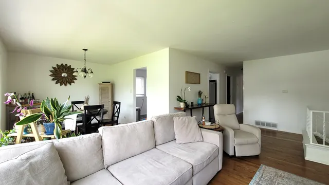a living room with furniture and a chandelier