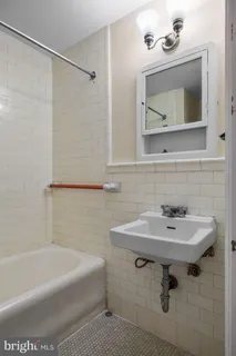 a bathroom with a sink toilet and mirror