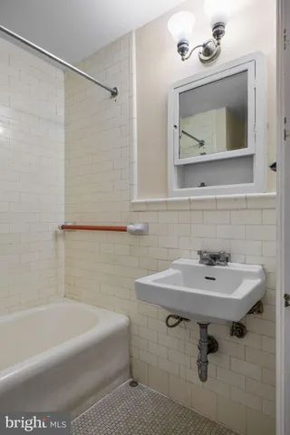 a bathroom with a sink toilet and mirror