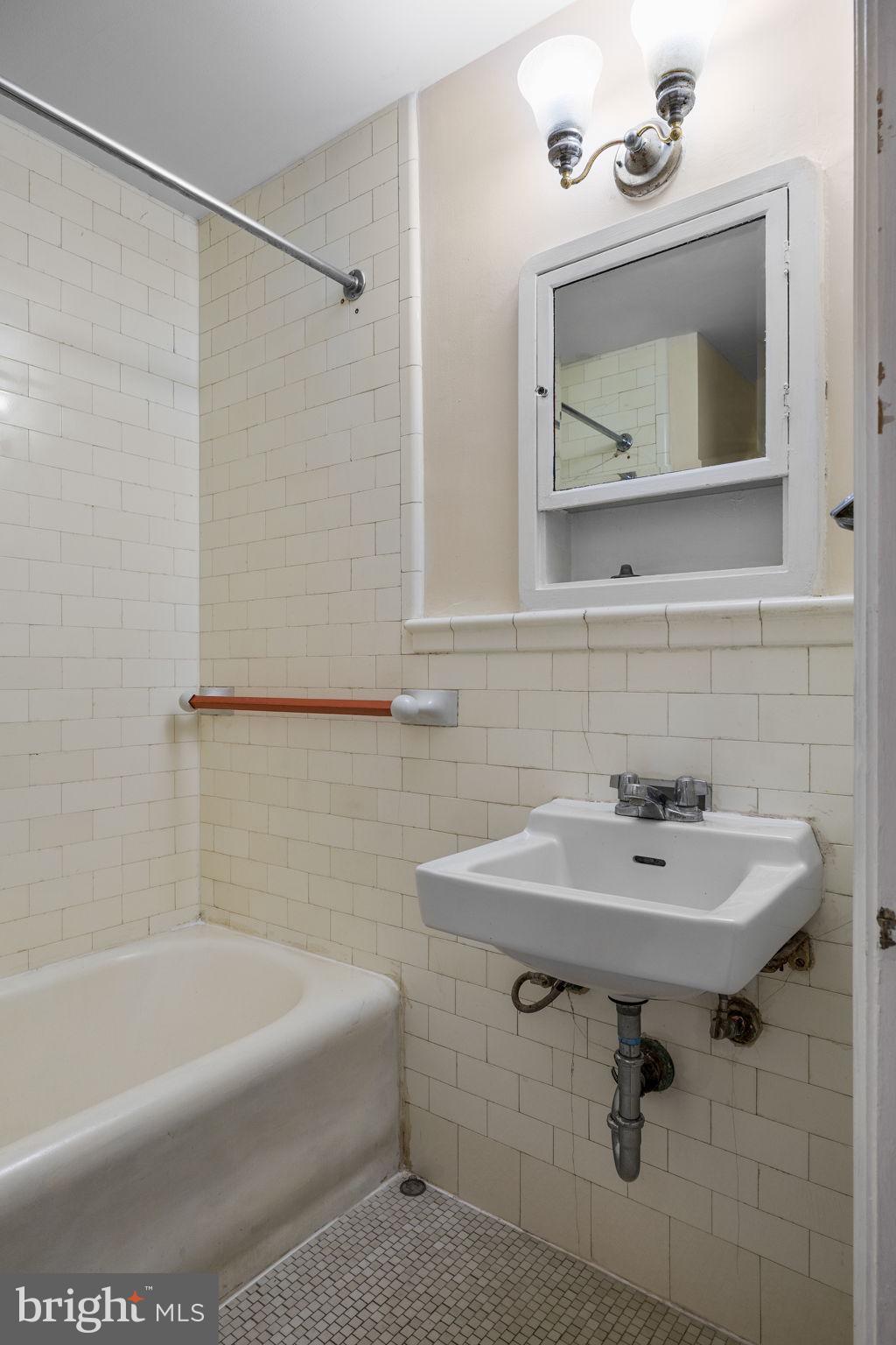 1324 Locust Street, Unit 807 Philadelphia, PA 19107 - Photo 12 of 36 a bathroom with a sink toilet and mirror