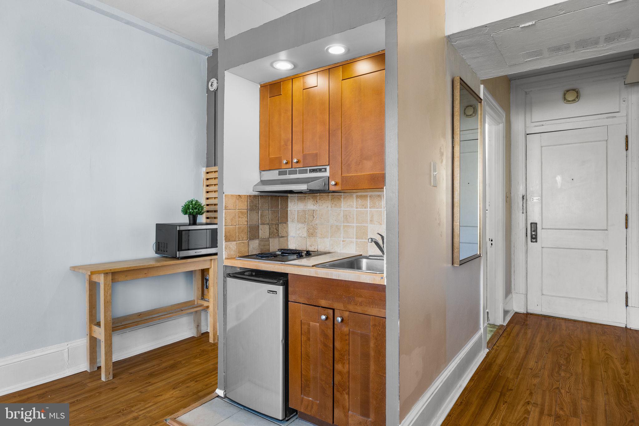 1324 Locust Street, Unit 807 Philadelphia, PA 19107 - Photo 14 of 36 a view of a kitchen with a sink and dishwasher
