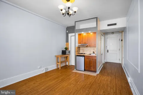 a view of a kitchen with wooden floor and a sink