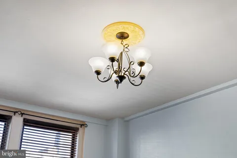 a view of a chandelier fan and a window