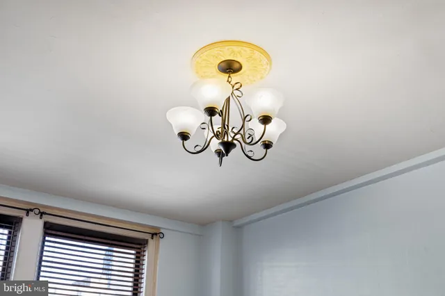a view of a chandelier fan and a window