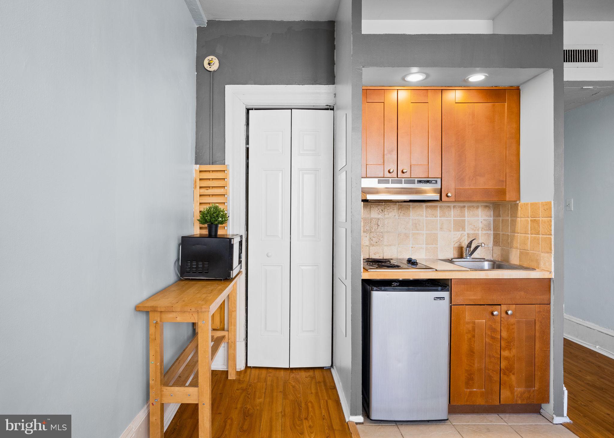 1324 Locust Street, Unit 807 Philadelphia, PA 19107 - Photo 24 of 36 a view of a storage and utility room with washer and dryer
