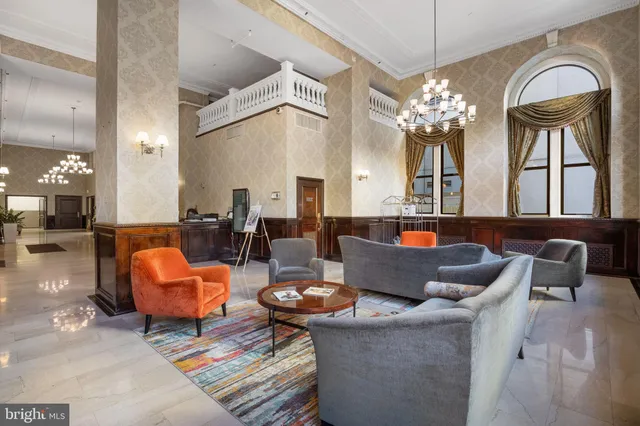 a living room with fireplace furniture and a chandelier