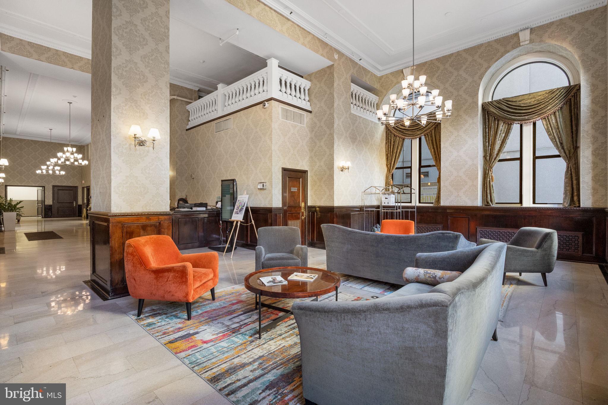 1324 Locust Street, Unit 807 Philadelphia, PA 19107 - Photo 29 of 36 a living room with fireplace furniture and a chandelier