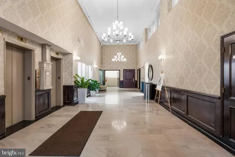 a lobby with furniture and a chandelier