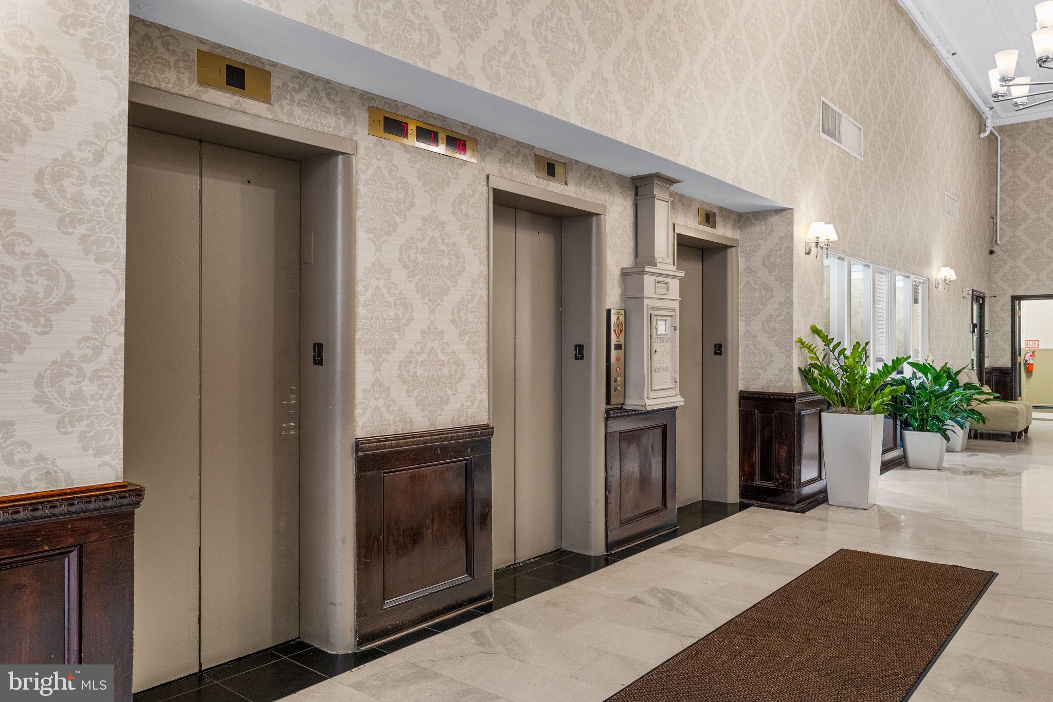 1324 Locust Street, Unit 807 Philadelphia, PA 19107 - Photo 32 of 36 a hallway with potted plants in front of door