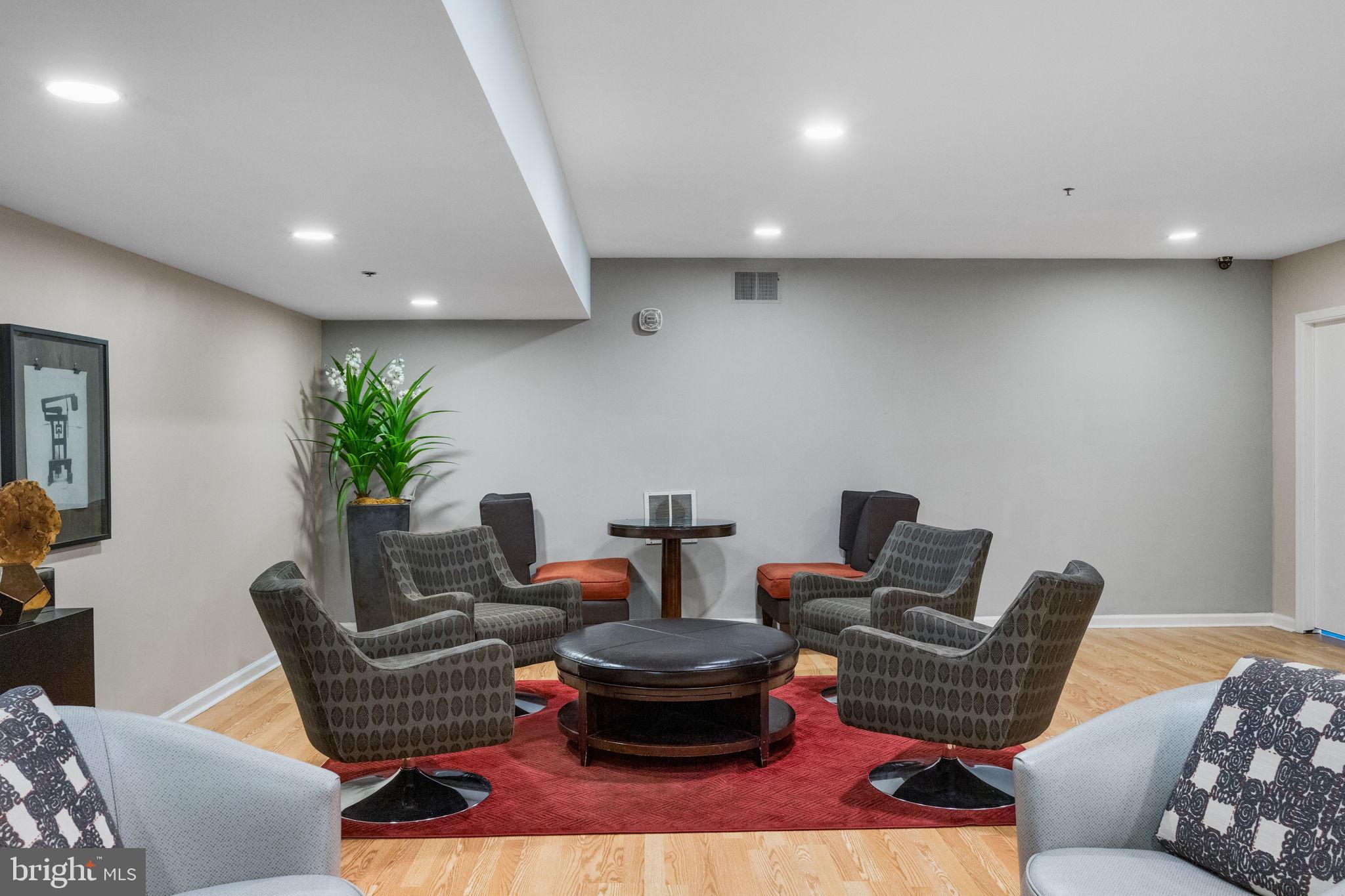 1324 Locust Street, Unit 807 Philadelphia, PA 19107 - Photo 36 of 36 a living room with furniture and a potted plant