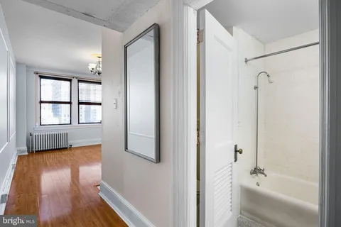 a bathroom with a tub shower and sink