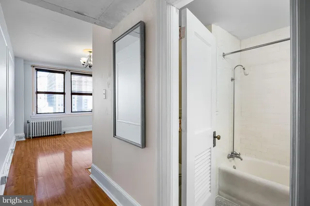 a bathroom with a tub shower and sink