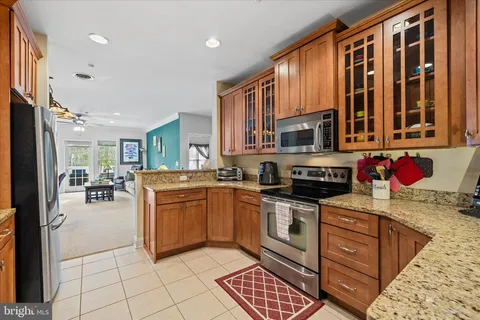 a view of a dining room and kitchen with furniture wooden floor and a rug