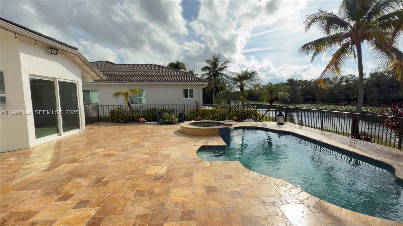 3763 Oak Ridge Circle Weston, FL 33331 - Photo 13 of 33 a swimming pool with outdoor seating and yard
