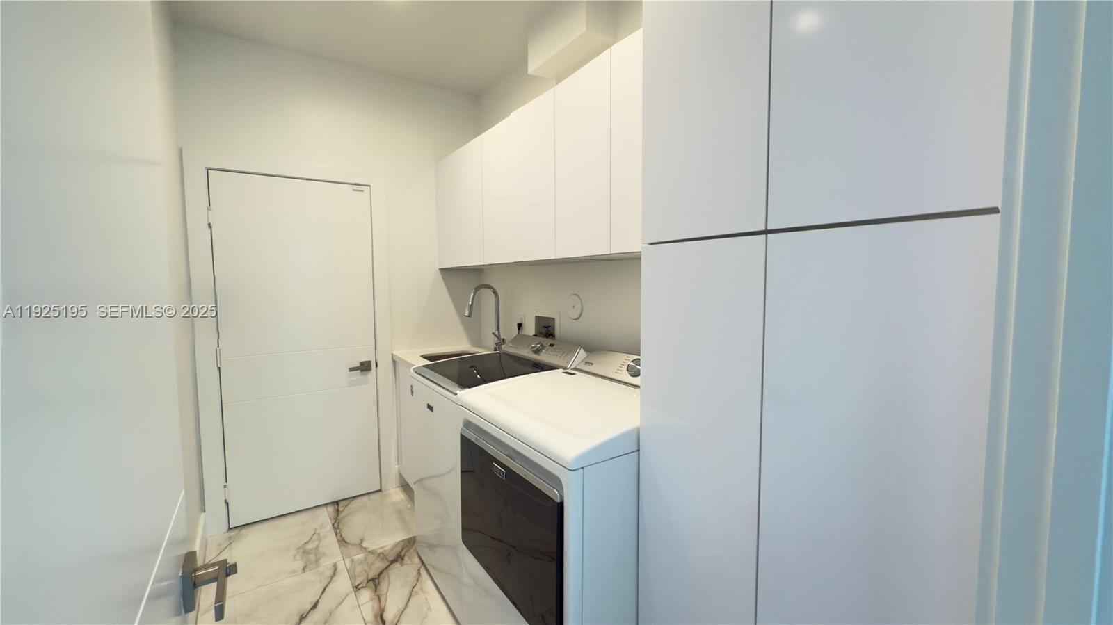 3763 Oak Ridge Circle Weston, FL 33331 - Photo 20 of 33 a room with a sink and a washer