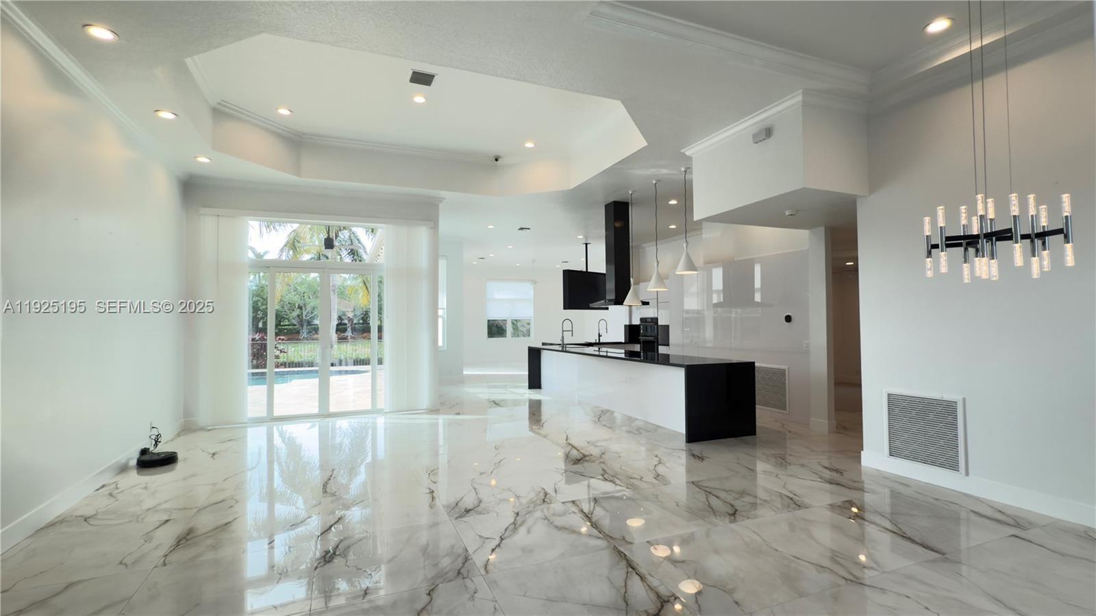 3763 Oak Ridge Circle Weston, FL 33331 - Photo 26 of 33 a large kitchen with stainless steel appliances kitchen island granite countertop a refrigerator and cabinets